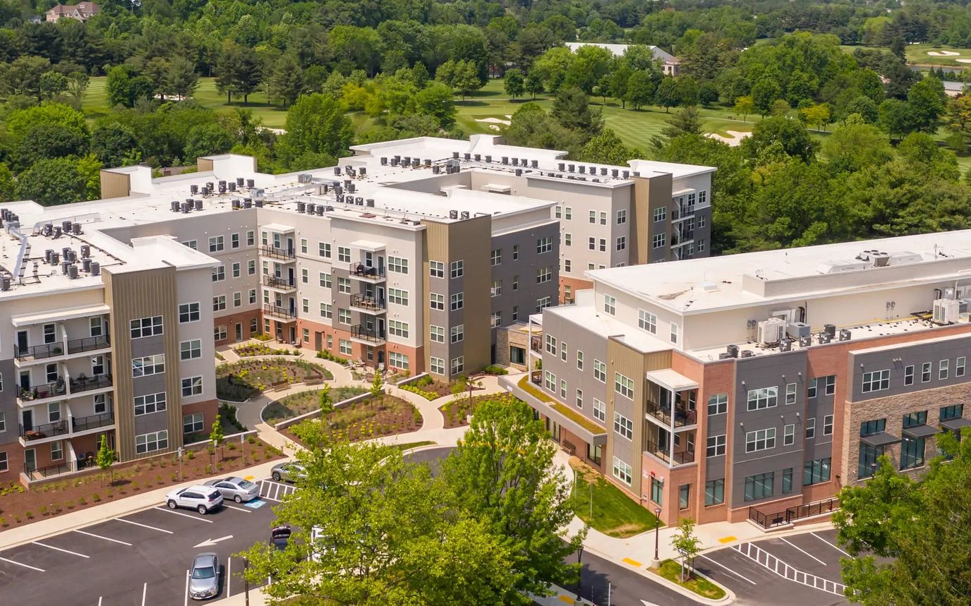 Aerial view of a senior living facility with gardens and walkways