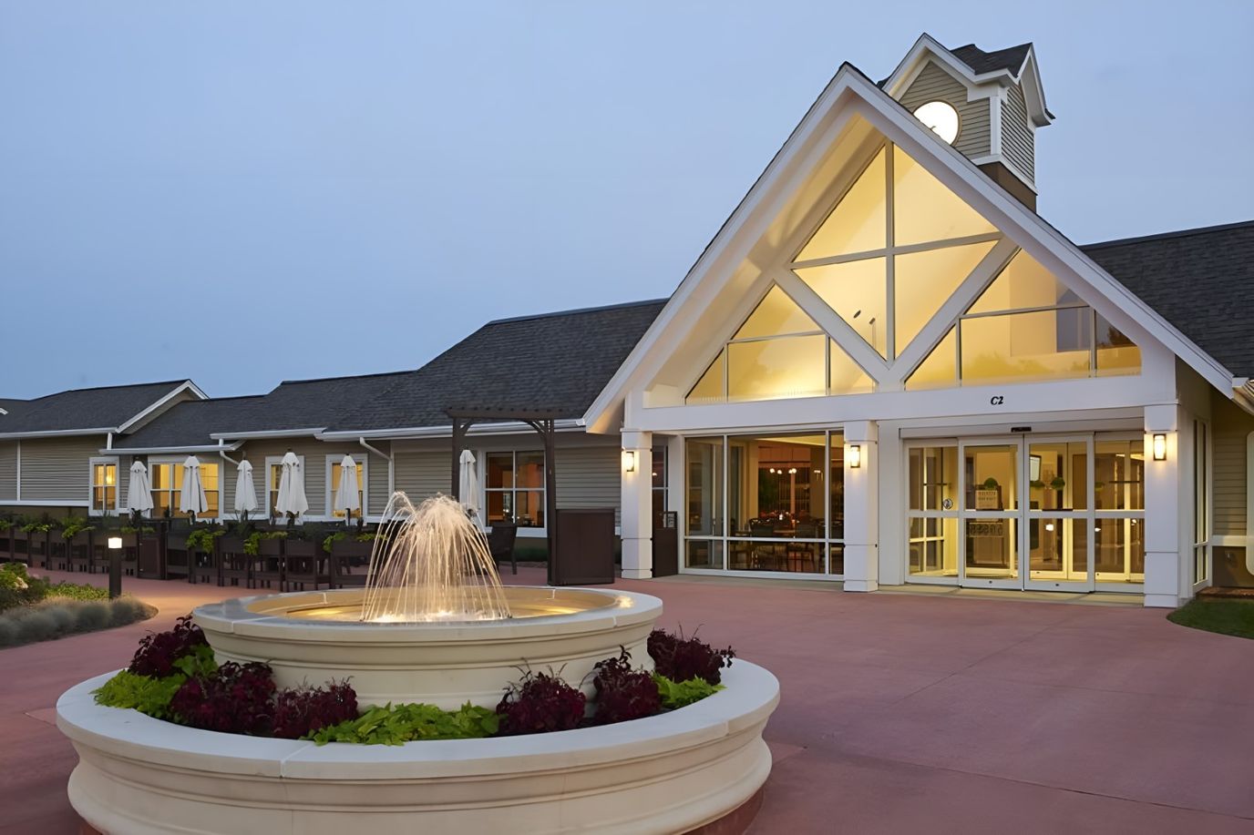 Exterior view of a senior living facility with fountain