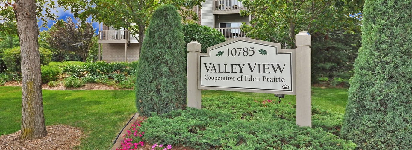 Sign for Valley View Cooperative among greenery