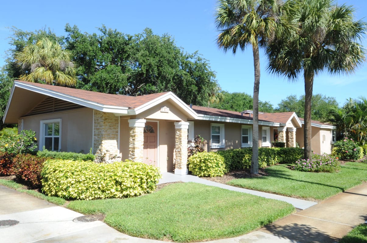 Exterior view of a single-story building with palm trees