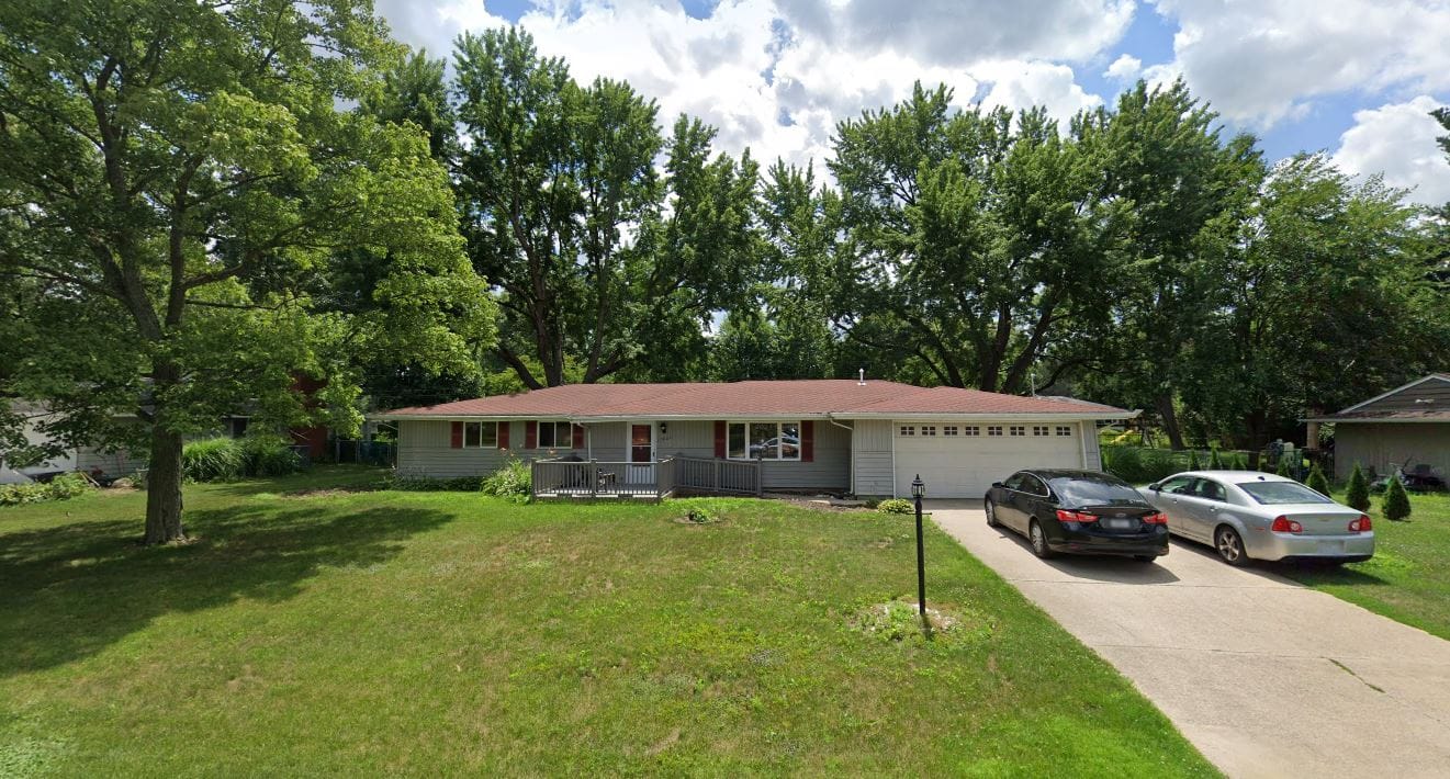 Exterior view of a single-story house with a yard