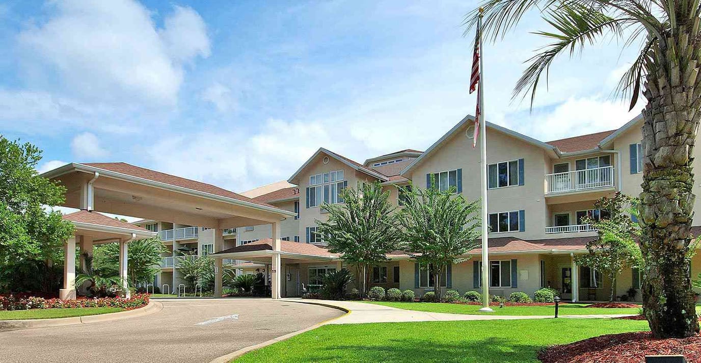 Exterior view of a senior living facility with landscaping