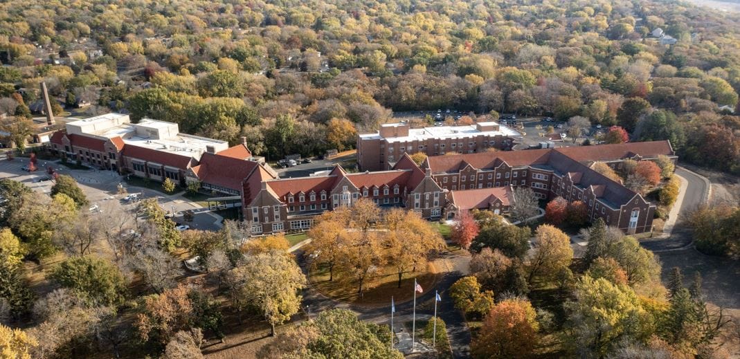 Aerial view of Minnesota Masonic Home surrounded by autumn trees