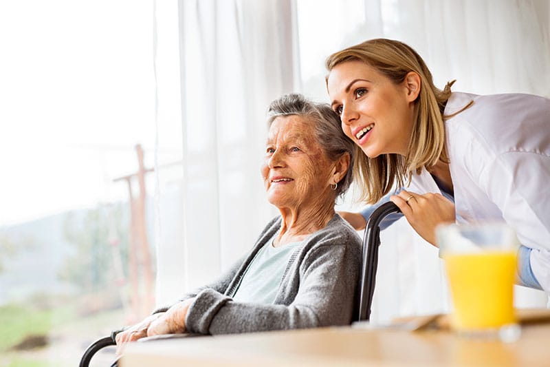 A caregiver and resident enjoying time together indoors