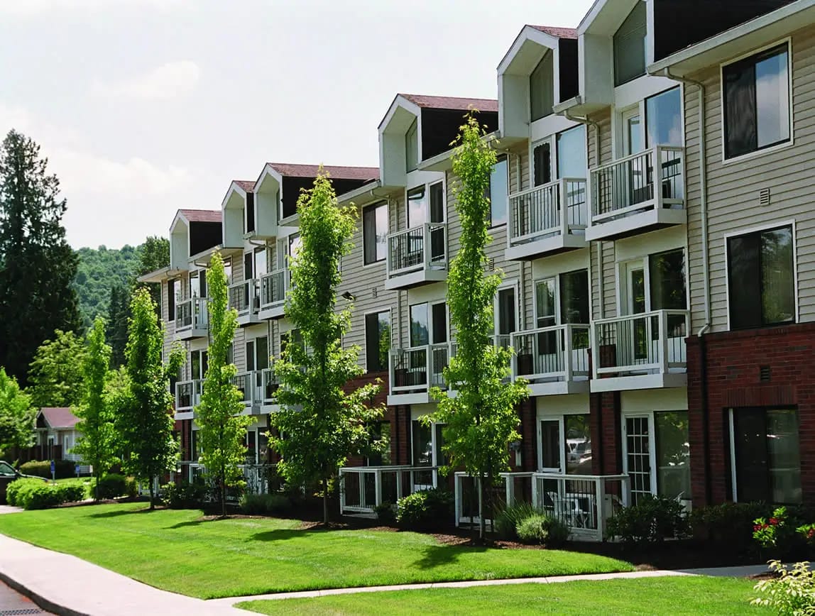 Exterior view of a senior living community with landscaped grounds