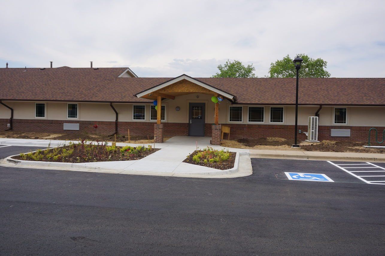 Exterior view of the facility entrance and garden