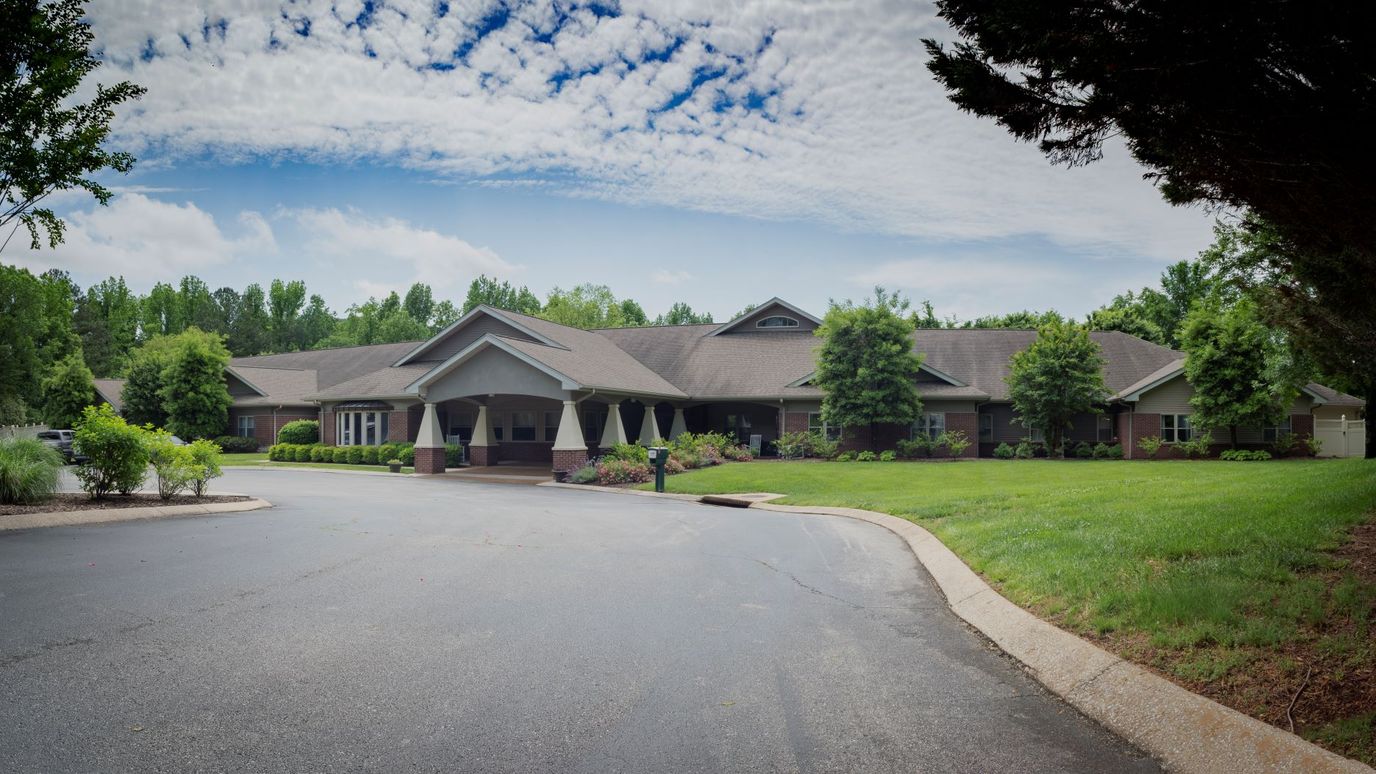 Exterior view of a senior living facility with landscaping