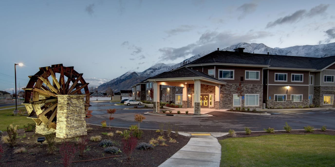 Exterior view of a nursing home with mountains in the background
