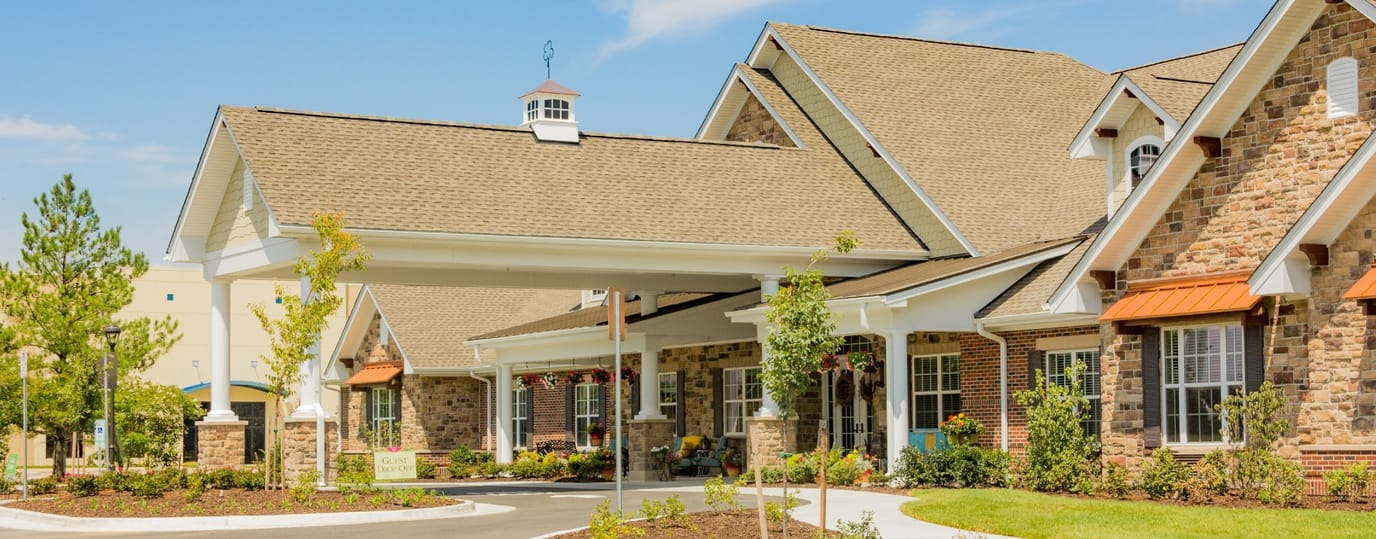 Exterior view of a senior living facility with landscaping
