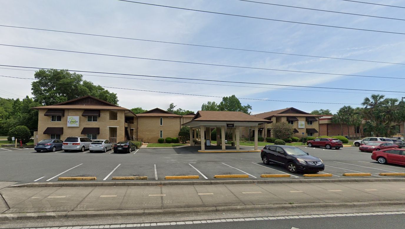 Exterior view of a senior living facility with parking lot