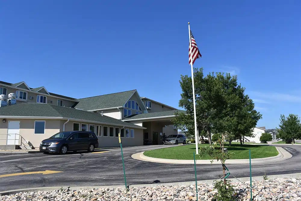Exterior view of Edgewood Rapid City facility with flag
