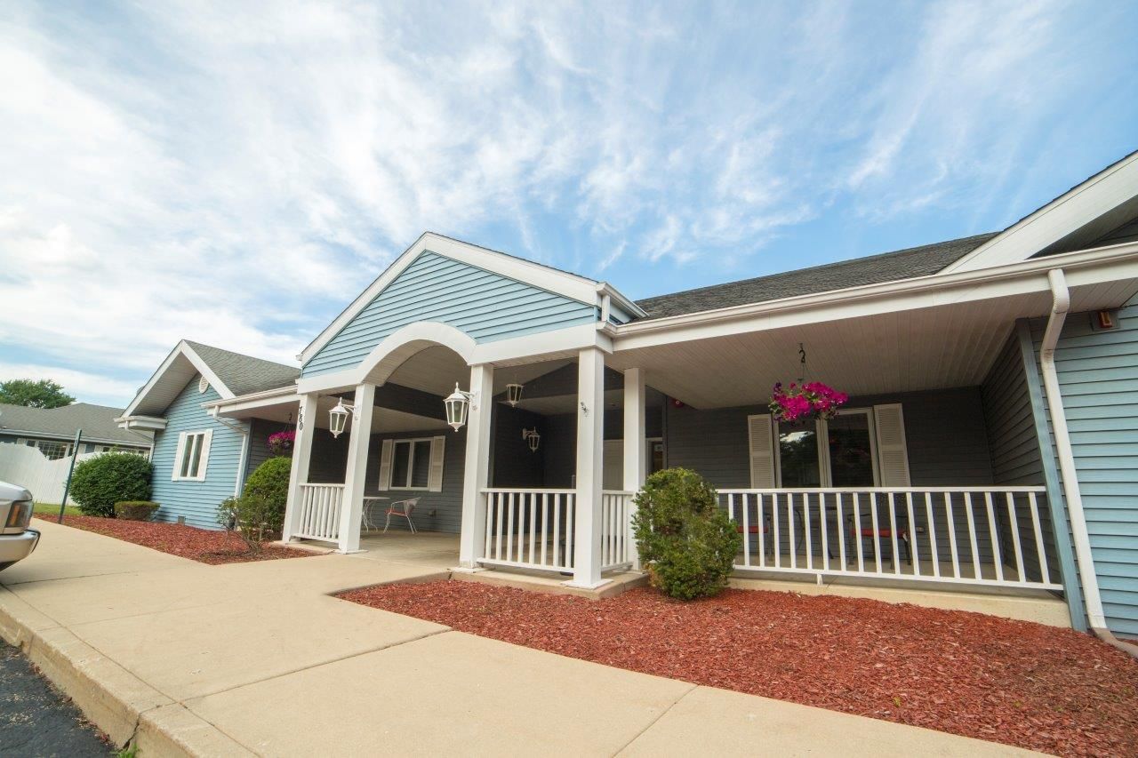 Exterior view of Harbor House Memory Care with flowers