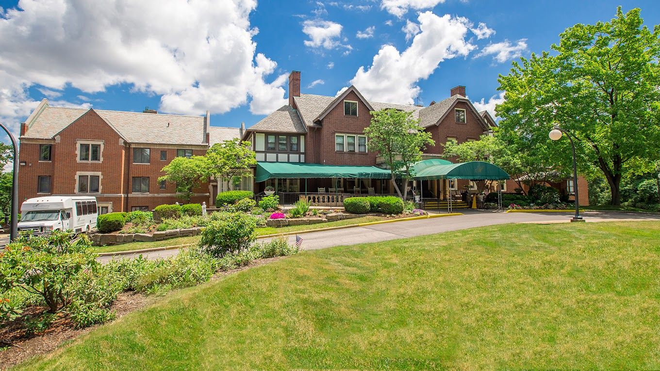 Exterior view of a senior living facility with garden