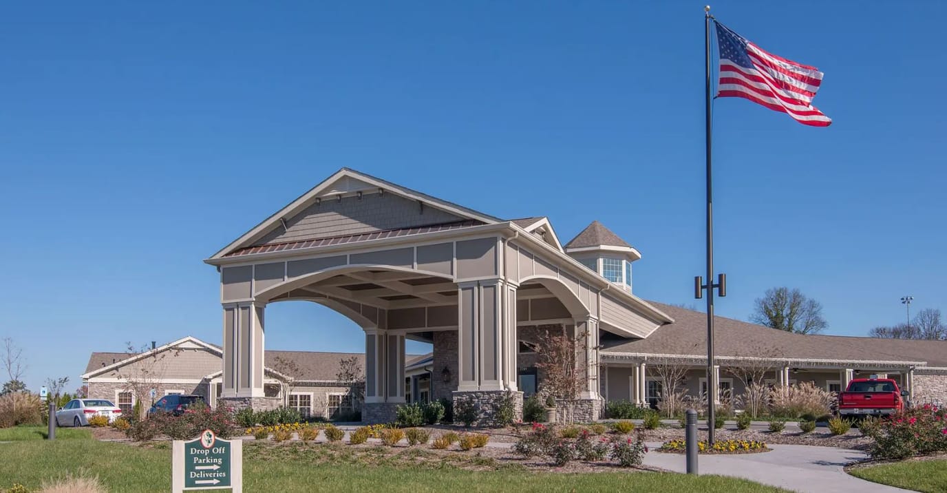 Exterior view of the facility with flag and garden