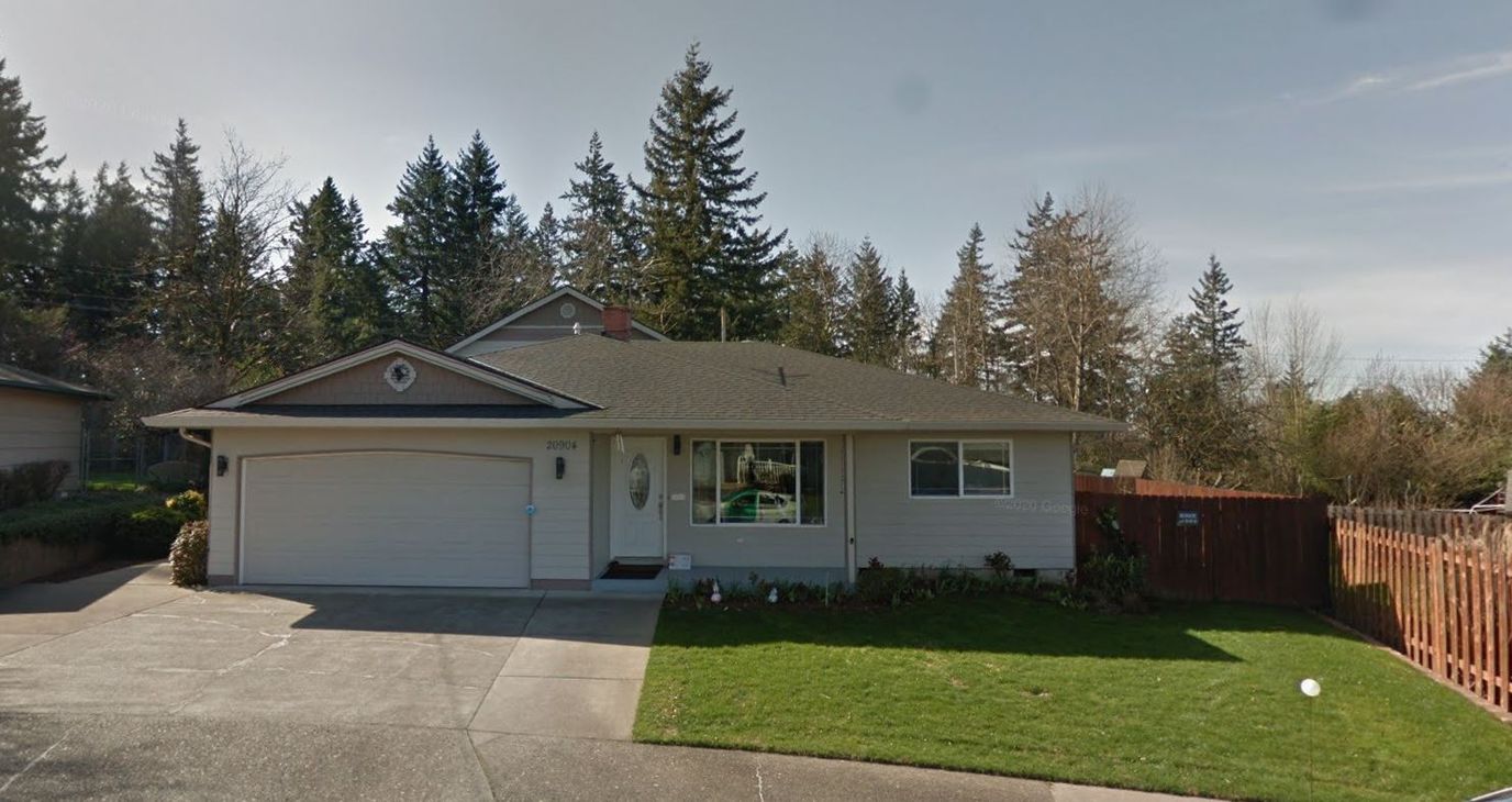Exterior view of a residential building with a yard
