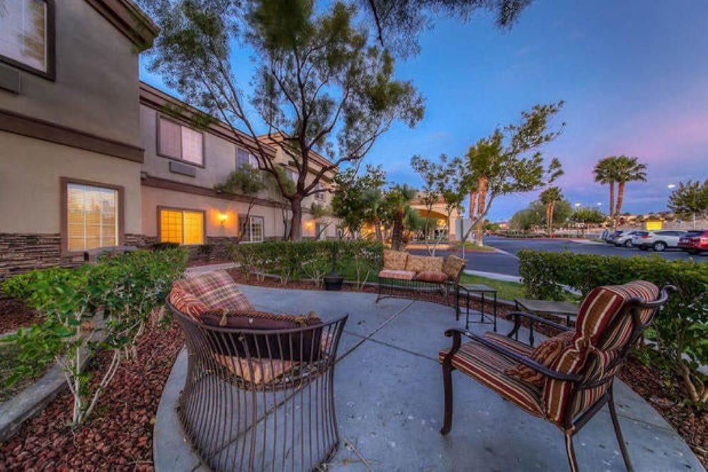 Outdoor seating area with trees and landscaping