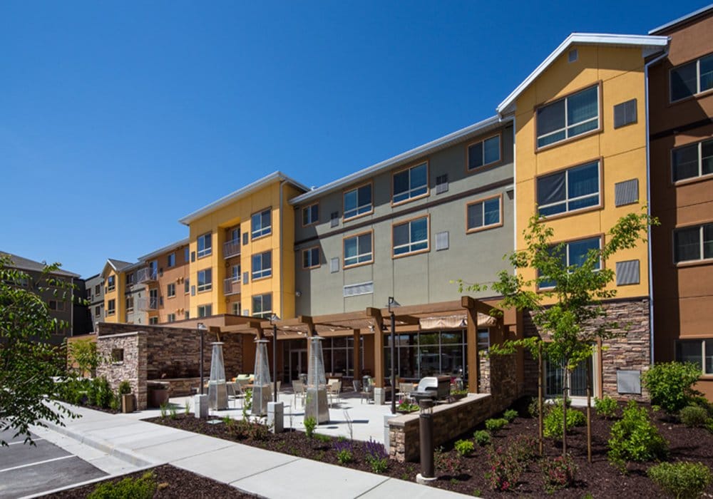 Outdoor view of the assisted living facility with patio and seating area