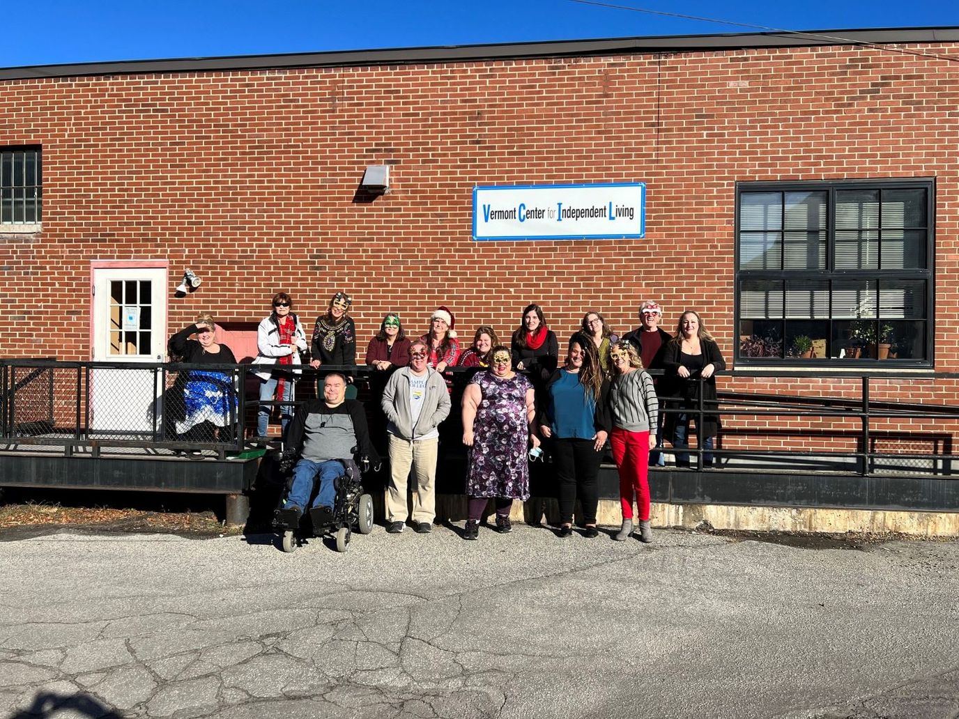 Group photo of residents and staff outside the facility
