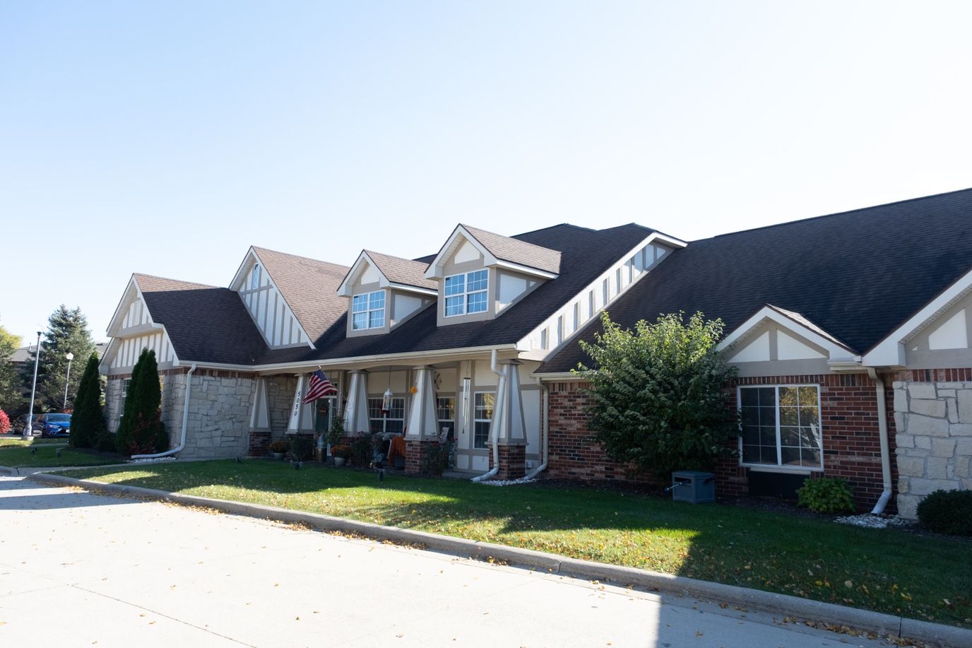 Exterior view of a senior living facility with garden