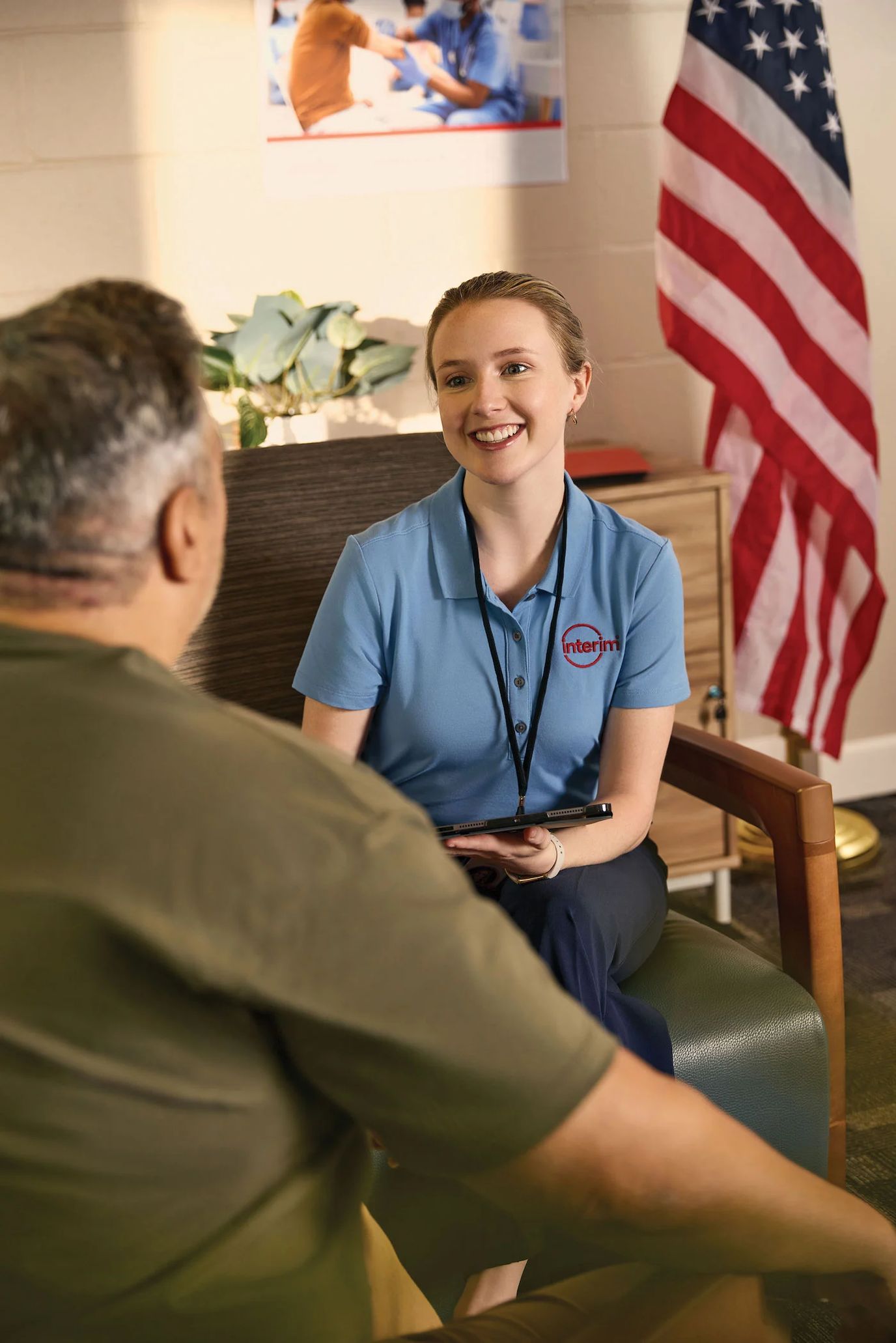 Interim HealthCare of Albuquerque, home care in Albuquerque, NM — Smiling caregiver interacting with senior resident in an office