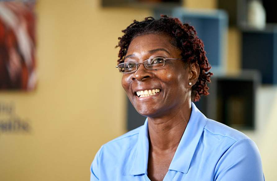 Smiling staff member in a facility environment