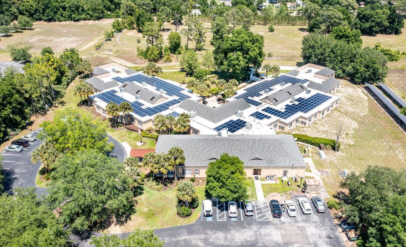 Aerial view of Ocala Senior Living facility with solar panels