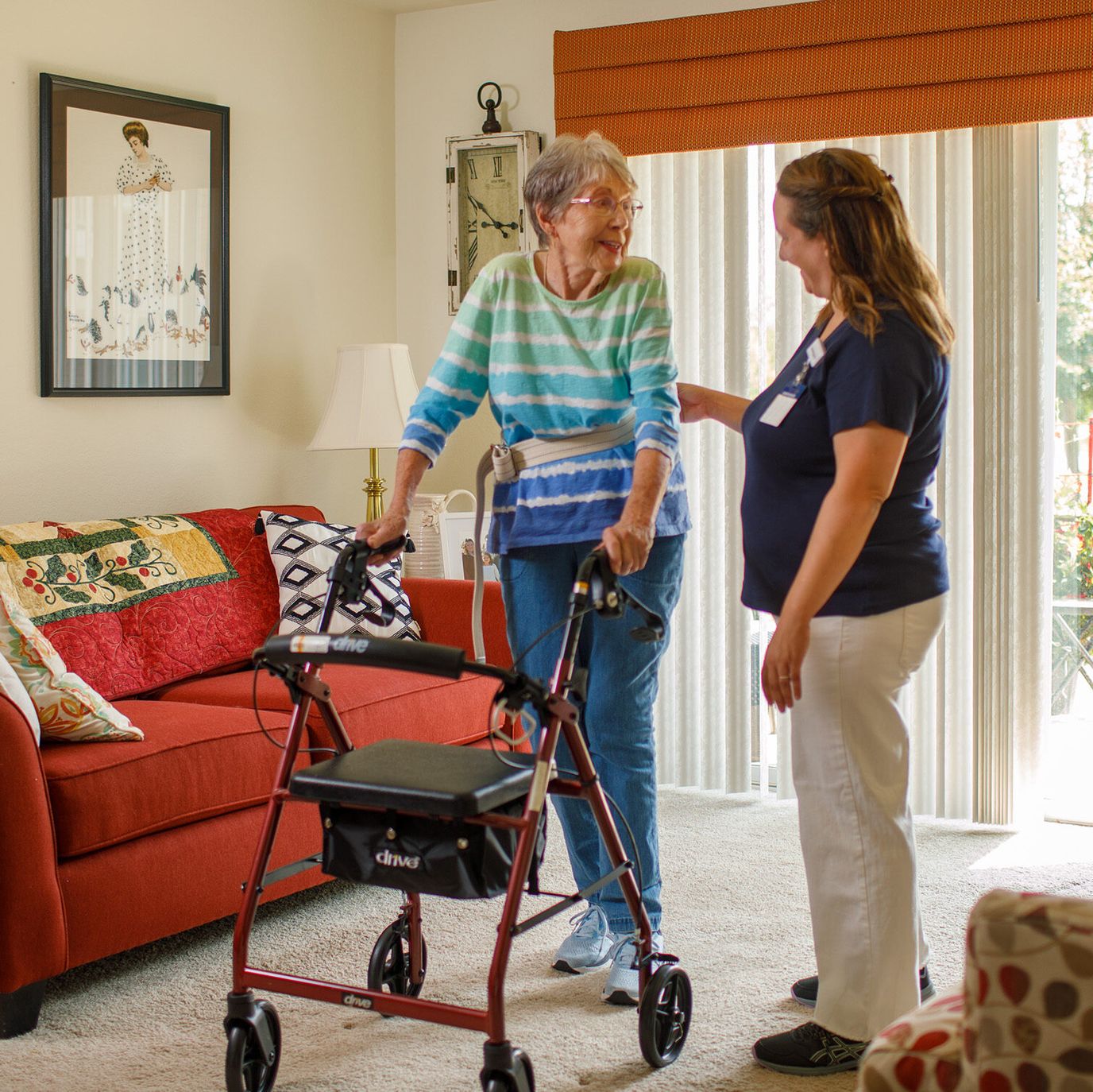 Staff assisting a resident in a cozy living room