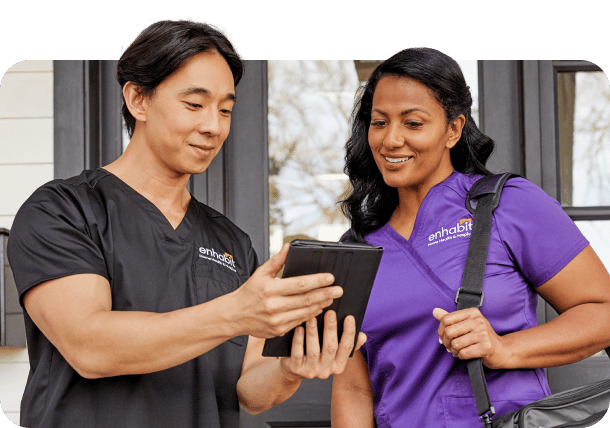 Healthcare professionals reviewing information on a tablet