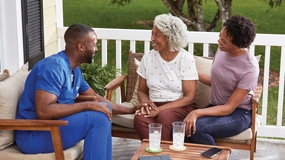 Healthcare professional engaging with seniors outdoors