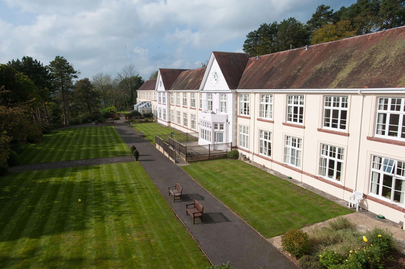 Exterior view of a senior living facility with landscaped gardens