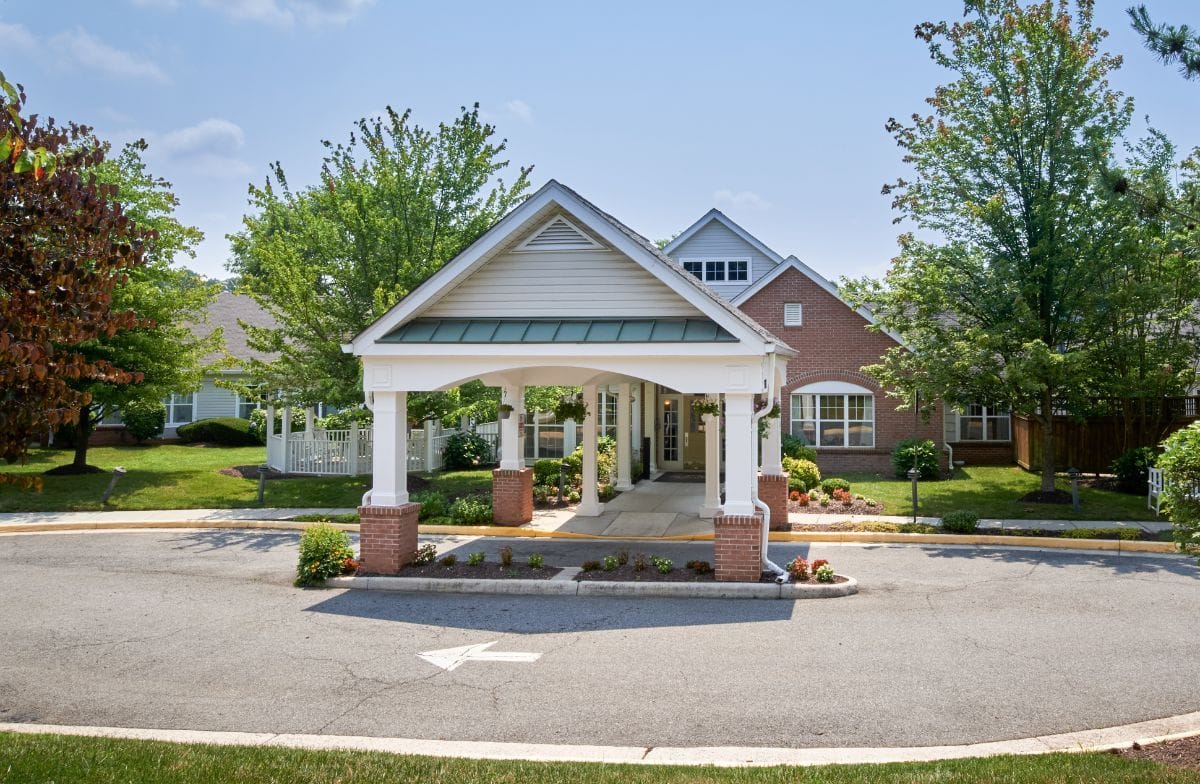 Entrance of a senior living facility with landscaping