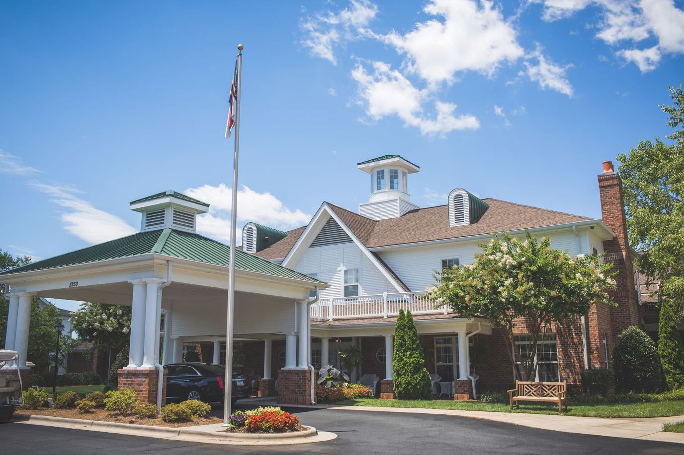 Exterior view of Homestead Hills facility with flag and landscaping