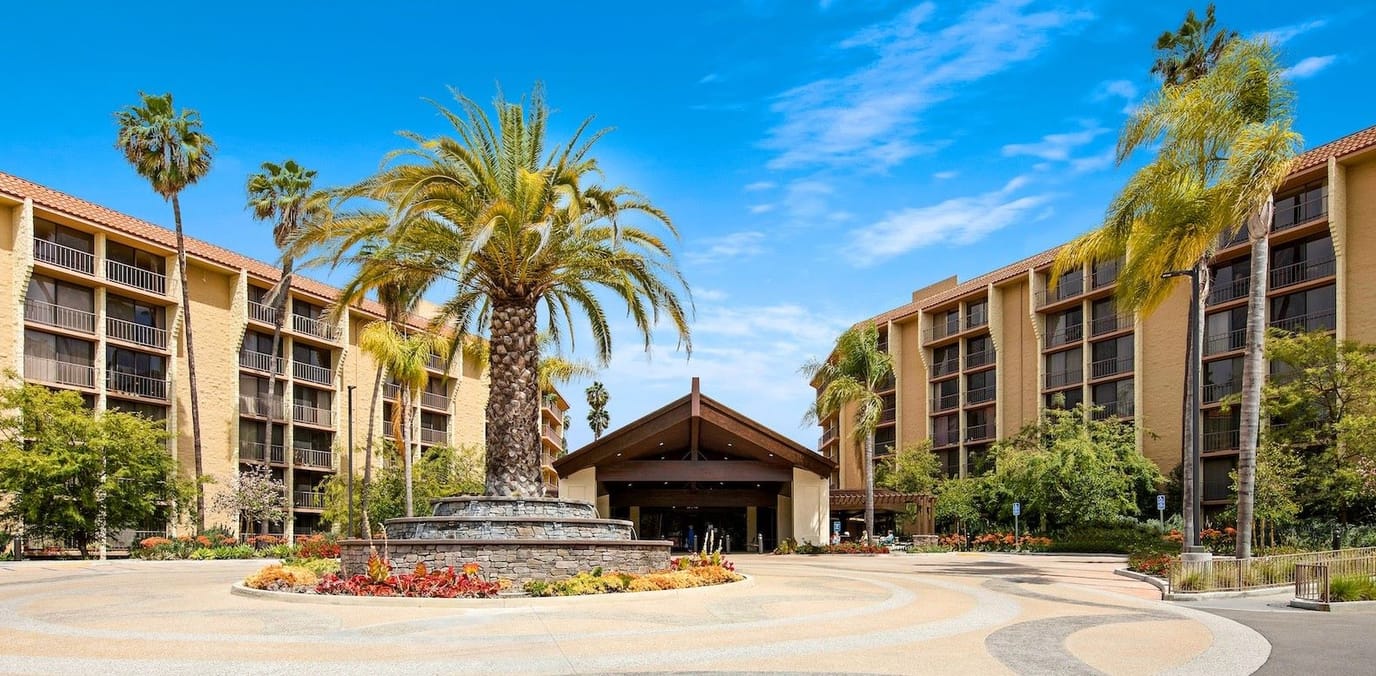 Welcoming entrance of Meridian at Laguna Hills with palm trees