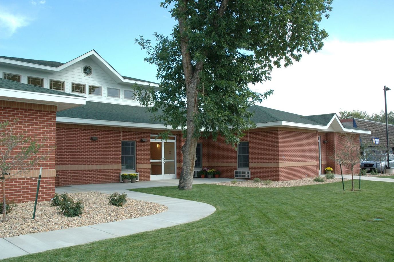 Exterior view of Peaks Care Center with landscaped lawn