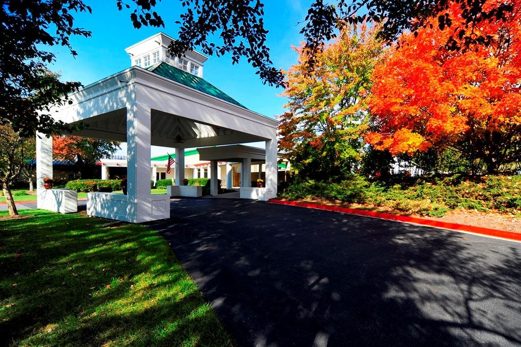 Entrance of Regency Park Senior Living with colorful trees