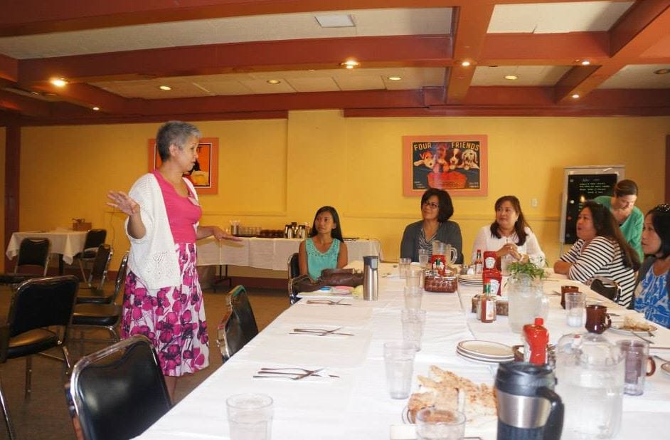Residents engaged in a group discussion in a common area