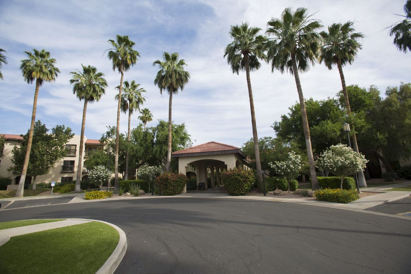Entrance of a senior living facility with palm trees