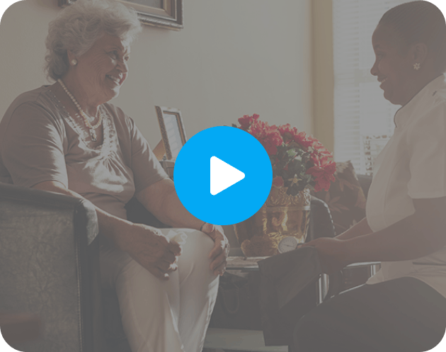 Senior resident enjoying conversation with staff member