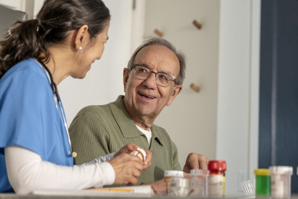 Caregiver and resident interacting during medication management