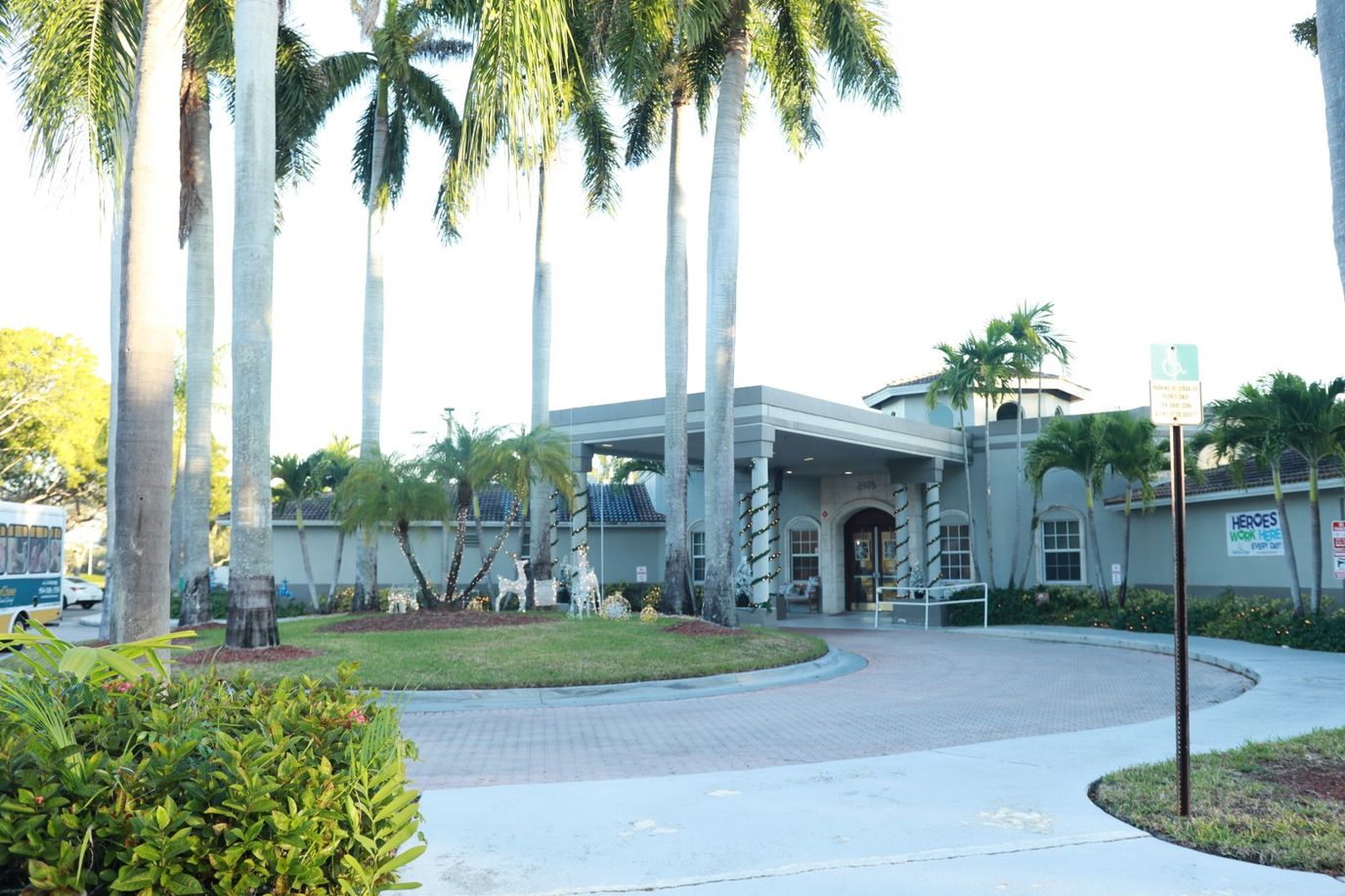 Front entrance of HarborChase of Coral Springs with landscaping