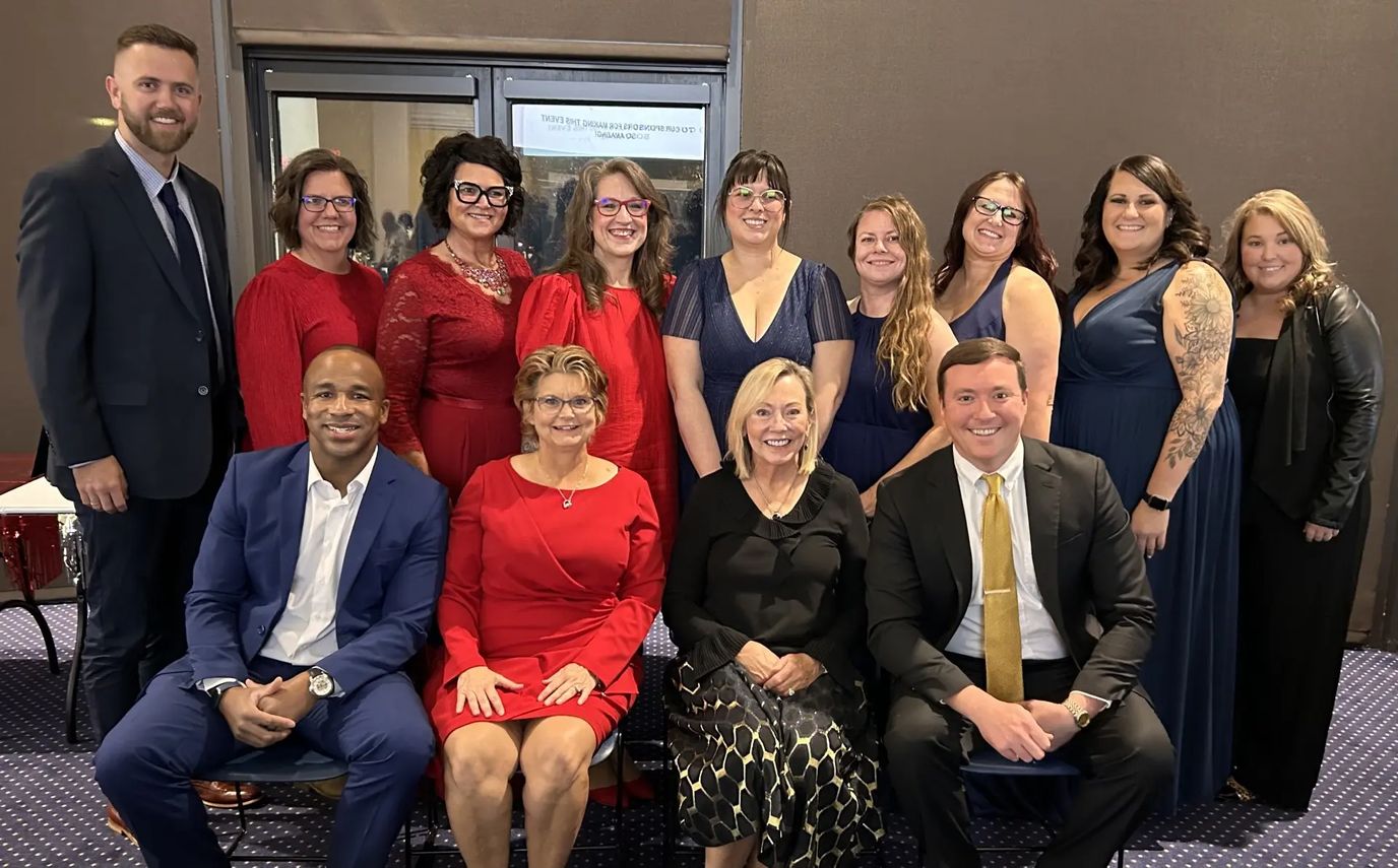 Staff and residents celebrating at a formal event