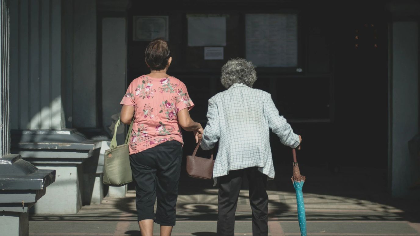 Two women walking toward a building entrance