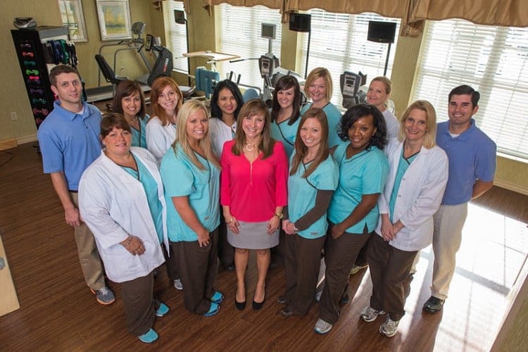 Staff members posing together in an activity room