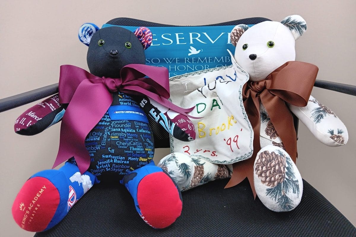 Two colorful teddy bears with ribbons