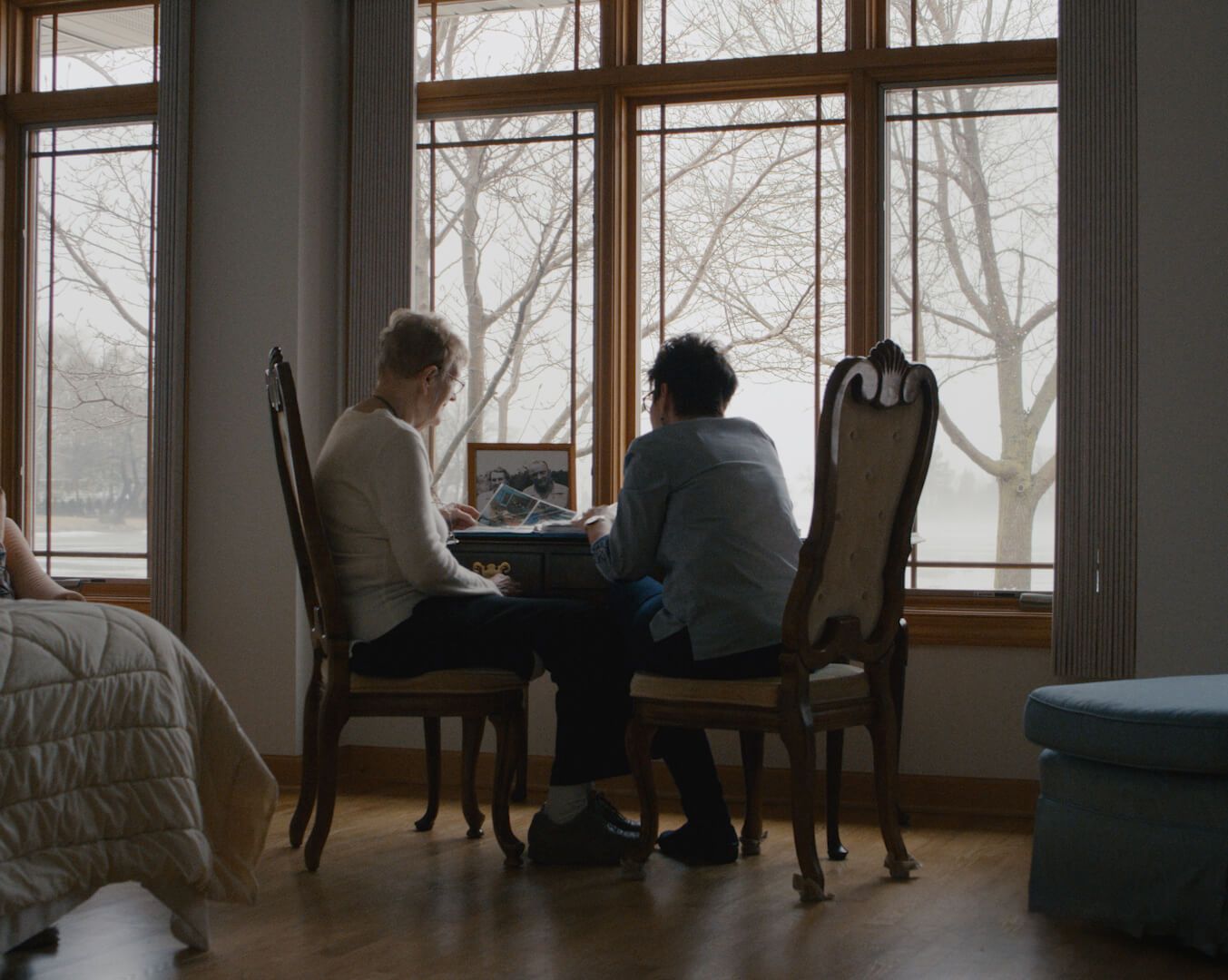 Two residents sharing a moment by the window