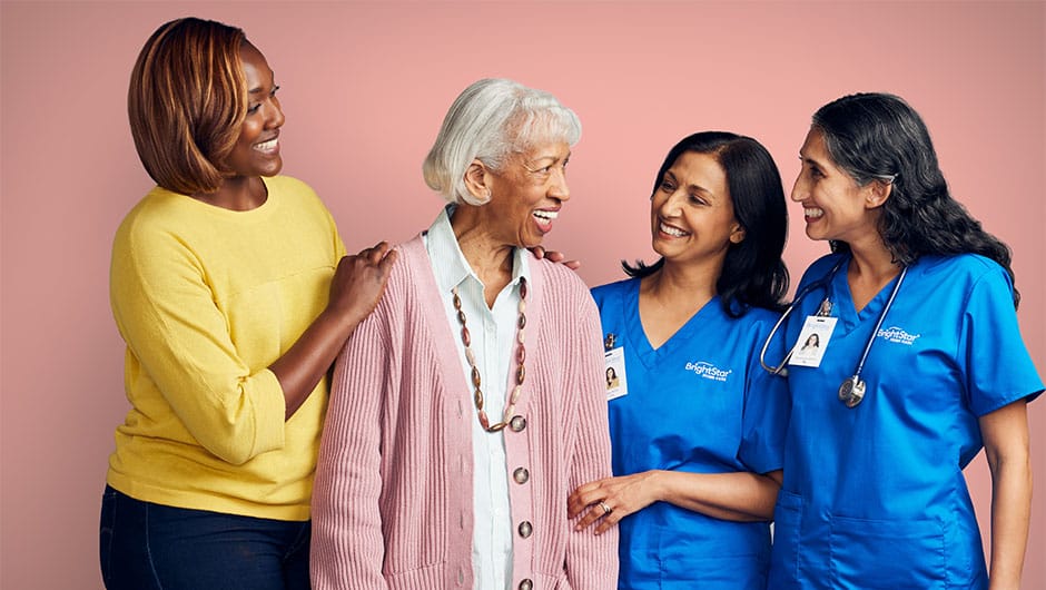 Care staff engaging with a resident and family member