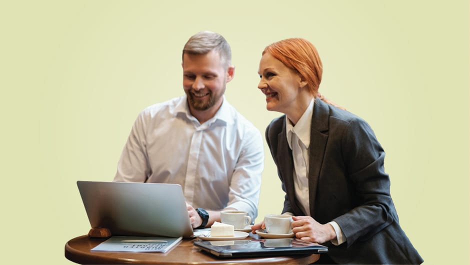 Business meeting with two people smiling over coffee