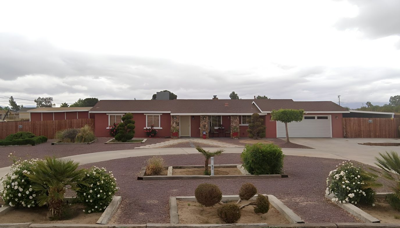 Exterior view of a senior living facility with gardens
