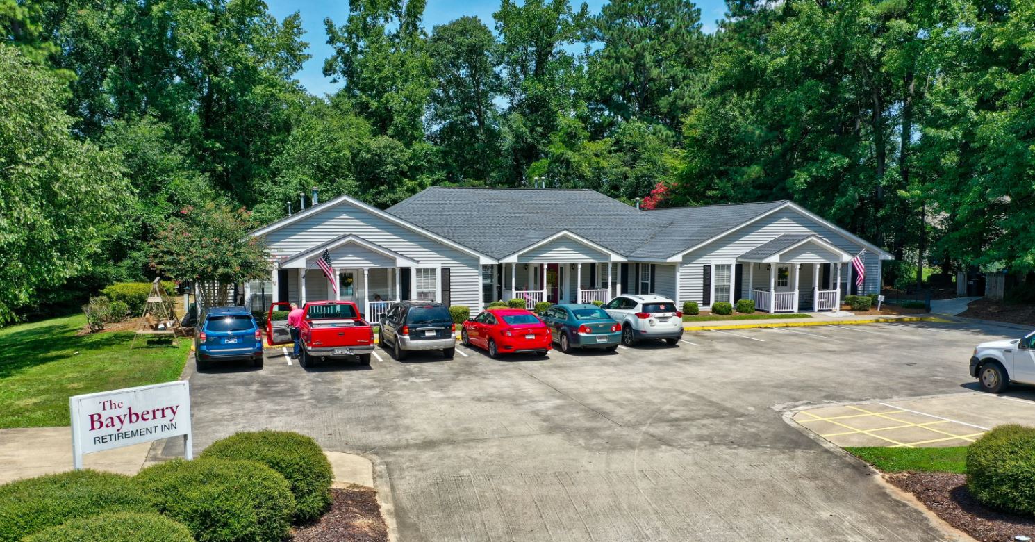Exterior view of Bayberry Retirement Inn with parking