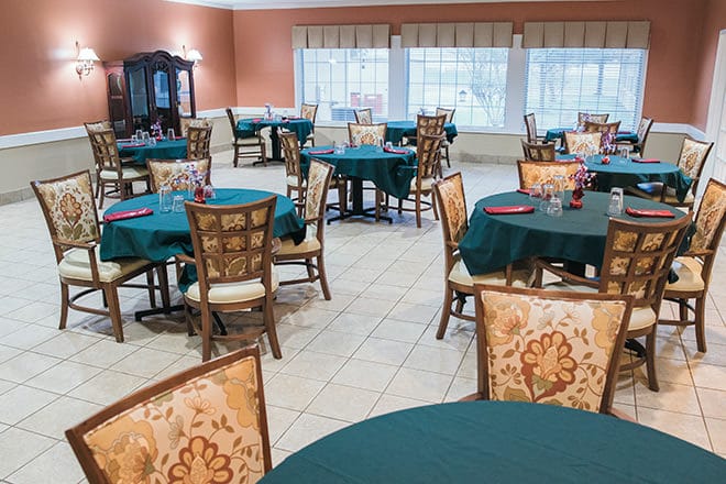 Dining area with tables set for residents